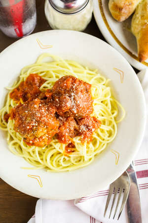 Spaghetti with meatballs on the plate in Italian restaurant.の写真素材