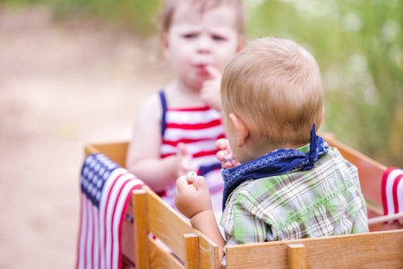 Toddlers having fun in the park for July Fourth.の写真素材