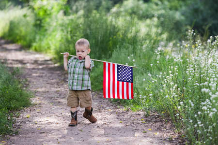 Toddlers having fun in the park for July Fourth.の写真素材