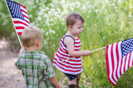 Toddlers having fun in the park for July Fourth.の写真素材