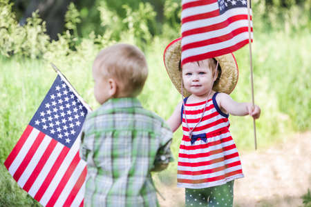 Toddlers having fun in the park for July Fourth.の写真素材