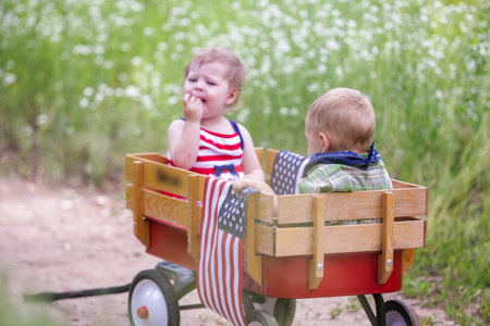 Toddlers having fun in the park for July Fourth.の写真素材