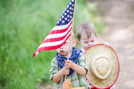 Toddlers having fun in the park for July Fourth.の写真素材