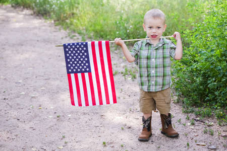 Toddlers having fun in the park for July Fourth.の写真素材