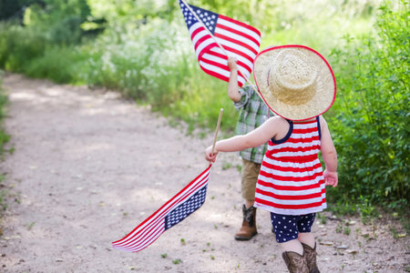 Toddlers having fun in the park for July Fourth.の写真素材
