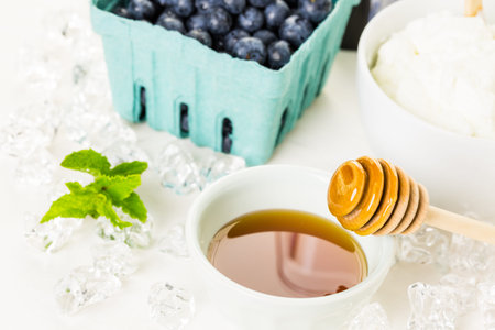 Ingredients to make smoothie with plain yogurt and fresh berries on the table.の写真素材