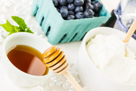 Ingredients to make smoothie with plain yogurt and fresh berries on the table.の写真素材