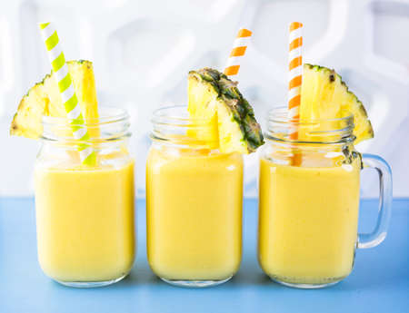 Homemade mango and pineapple smoothie made with coonut milk.の写真素材