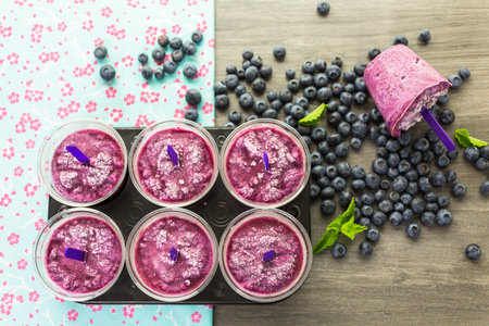 Homemade fruit popsicle made in plastic cups.の写真素材