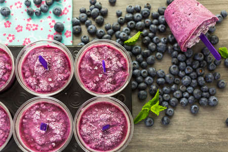 Homemade fruit popsicle made in plastic cups.の写真素材