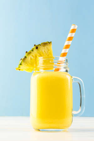 Homemade mango and pineapple smoothie made with coonut milk.の写真素材