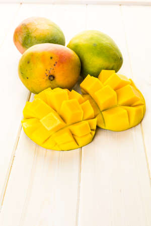 Fresh organic mango on a white wood board.の写真素材