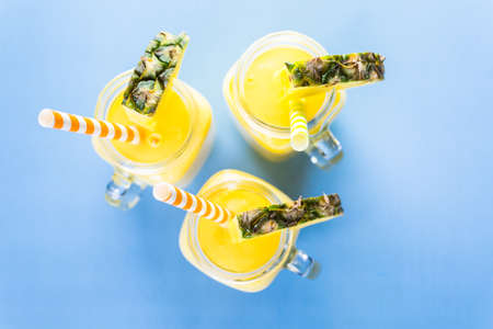 Homemade mango and pineapple smoothie made with coonut milk.の写真素材