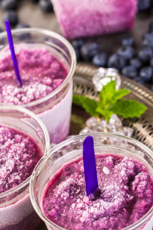 Homemade fruit popsicle made in plastic cups.の写真素材