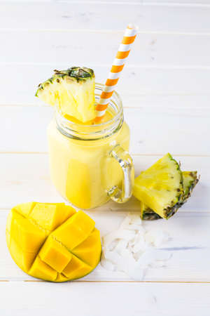Homemade mango and pineapple smoothie made with coonut milk.の写真素材