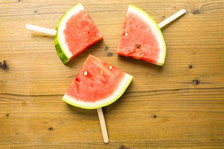 Yummy watermelon slice popsicles for refreshing treat.の写真素材