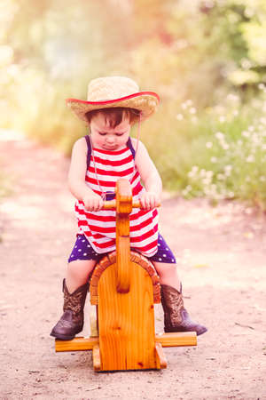 Toddlers having fun in the park for July Fourth.の写真素材