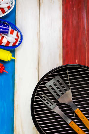 Small round charcoal grill ready for grilling at the summer picnic.の写真素材