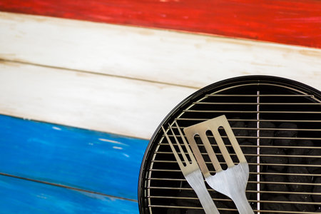 Small round charcoal grill ready for grilling at the summer picnic.の写真素材