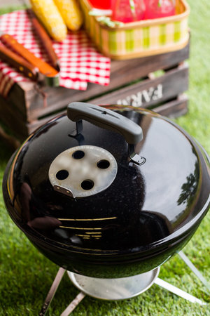 Summer picnic with small charcoal grill in the park.の写真素材