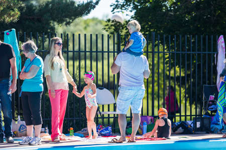Denver, Colorado, USA-July 11, 2015. Kids swim meet in outdoor pool during the summer.のeditorial素材