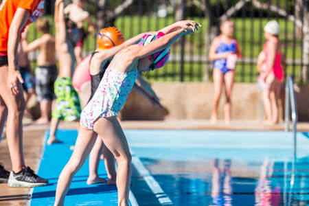 Denver, Colorado, USA-July 11, 2015. Kids swim meet in outdoor pool during the summer.のeditorial素材