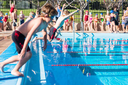 Denver, Colorado, USA-July 11, 2015. Kids swim meet in outdoor pool during the summer.のeditorial素材