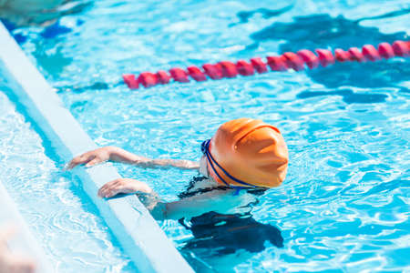 Denver, Colorado, USA-July 11, 2015. Kids swim meet in outdoor pool during the summer.のeditorial素材