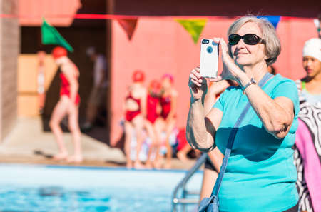 Denver, Colorado, USA-July 11, 2015. Kids swim meet in outdoor pool during the summer.のeditorial素材