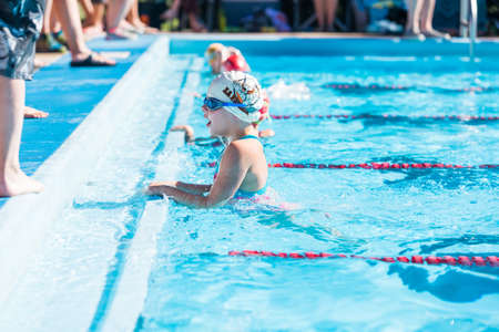 Denver, Colorado, USA-July 11, 2015. Kids swim meet in outdoor pool during the summer.のeditorial素材
