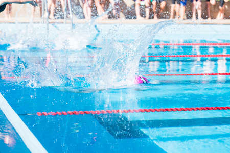 Denver, Colorado, USA-July 11, 2015. Kids swim meet in outdoor pool during the summer.のeditorial素材