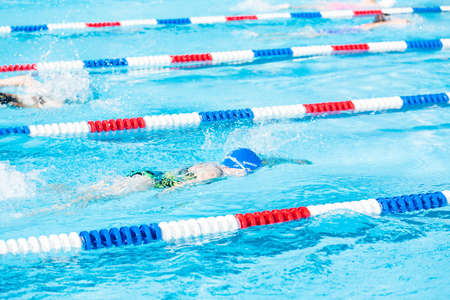 Denver, Colorado, USA-July 11, 2015. Kids swim meet in outdoor pool during the summer.のeditorial素材
