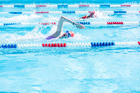 Denver, Colorado, USA-July 11, 2015. Kids swim meet in outdoor pool during the summer.のeditorial素材