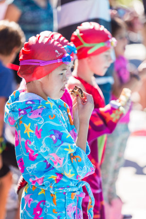 Denver, Colorado, USA-July 11, 2015. Kids swim meet in outdoor pool during the summer.のeditorial素材