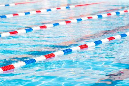 Kids swim meet in outdoor pool during the summer.の写真素材