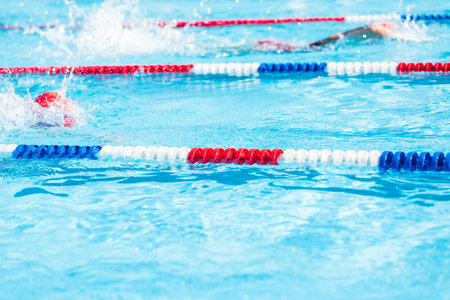 Kids swim meet in outdoor pool during the summer.の写真素材