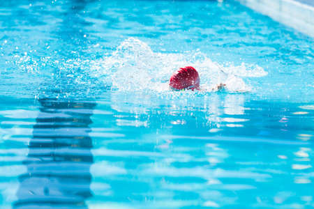 Kids swim meet in outdoor pool during the summer.の写真素材