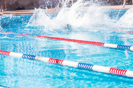 Kids swim meet in outdoor pool during the summer.の写真素材