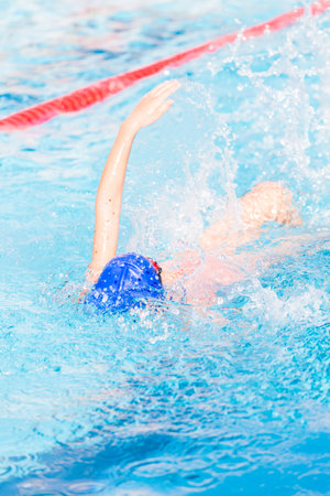 Kids swim meet in outdoor pool during the summer.の写真素材