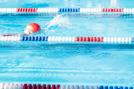 Kids swim meet in outdoor pool during the summer.の写真素材