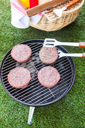 Small summer picnic with lemonade and hamburgers in the park.の写真素材