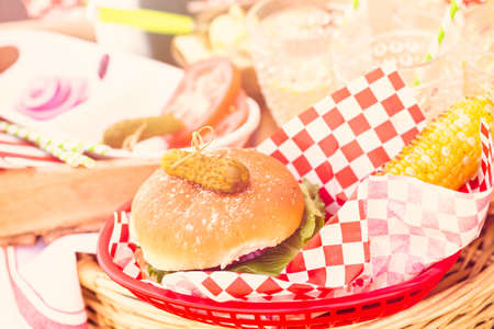 Small summer picnic with lemonade and hamburgers in the park.の写真素材