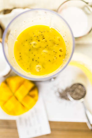 Freshly made mango banana smoothie with chia seeds.の写真素材