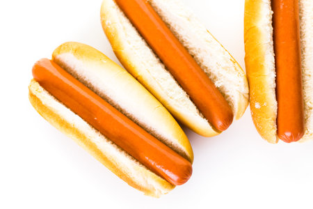 Traditional hot dogs on a white hot dog bun on a white background.の写真素材