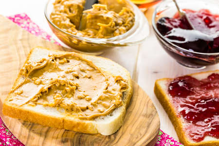 Homemade peanut butter and jelly sandwich on white bread.の写真素材