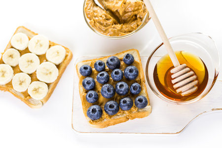 Homemade peanut butter and blueberry sandwich on white bread.の写真素材