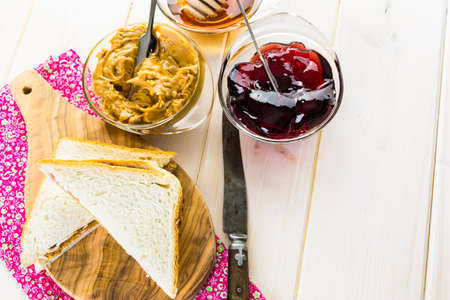 Homemade peanut butter and jelly sandwich on white bread.の写真素材
