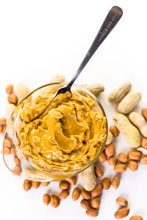 Extra chunky peanut butter on a white background.の写真素材