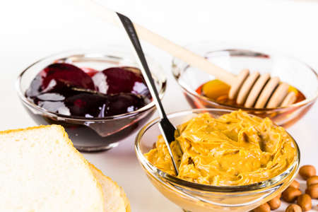 Homemade peanut butter and jelly sandwich on white bread.の写真素材