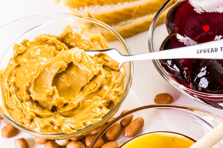 Homemade peanut butter and jelly sandwich on white bread.の写真素材